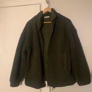 Green teddy jacket. Note small pieces of fuzz on it.